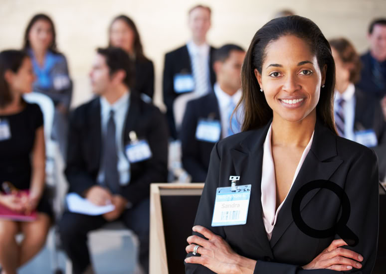 An image showing a facilitator about to deliver an interactive presentation to attendees in the background. 